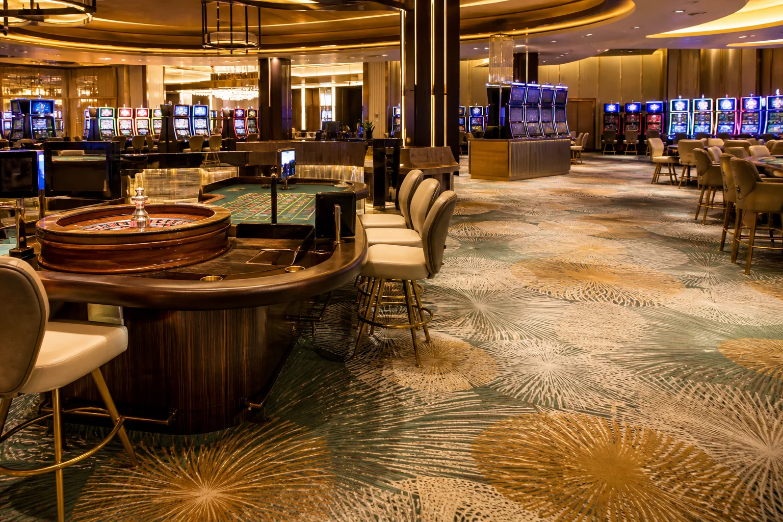 Patterned casino carpet flowing between roulette tables and slot-machine banks